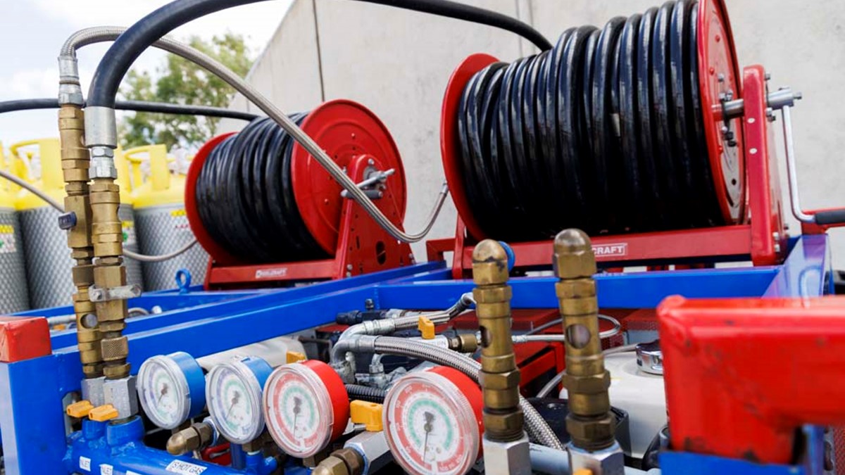 Rolls of black wire on top of blue recovery equipment