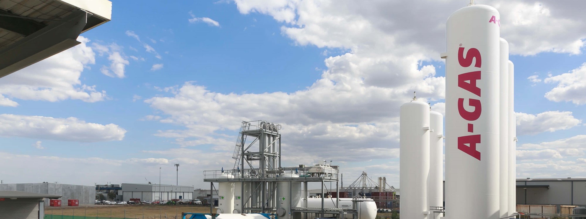 The A-Gas Australia site from a wide angle above shot, there are A-Gas branded industrial cylinders in the foreground of the image