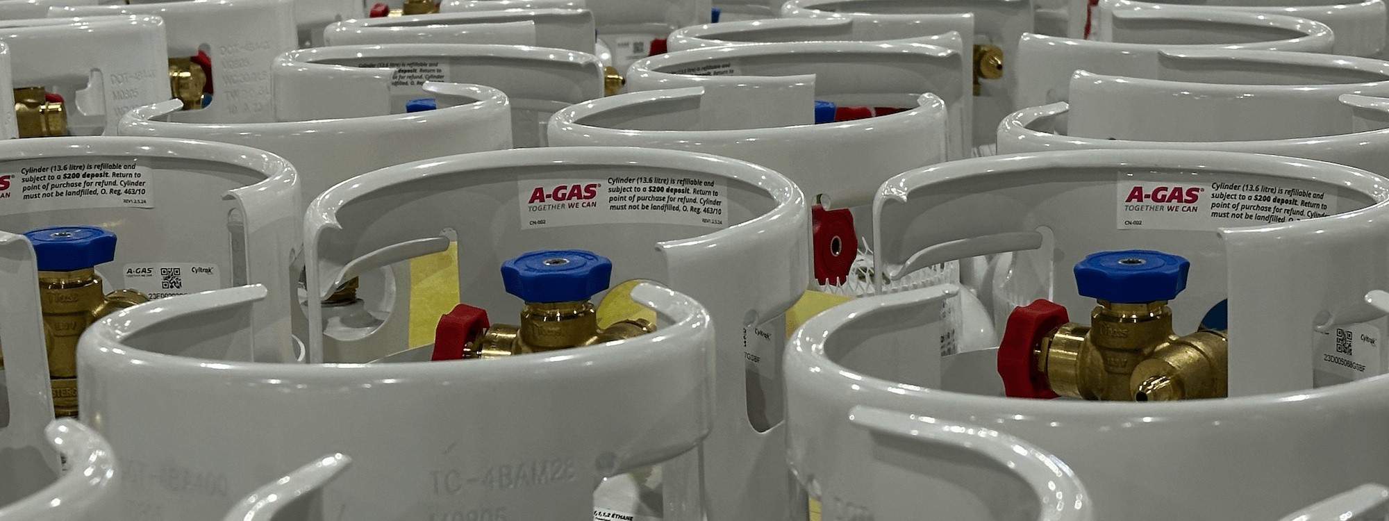 Rows of grey cylinders in a warehouse 
