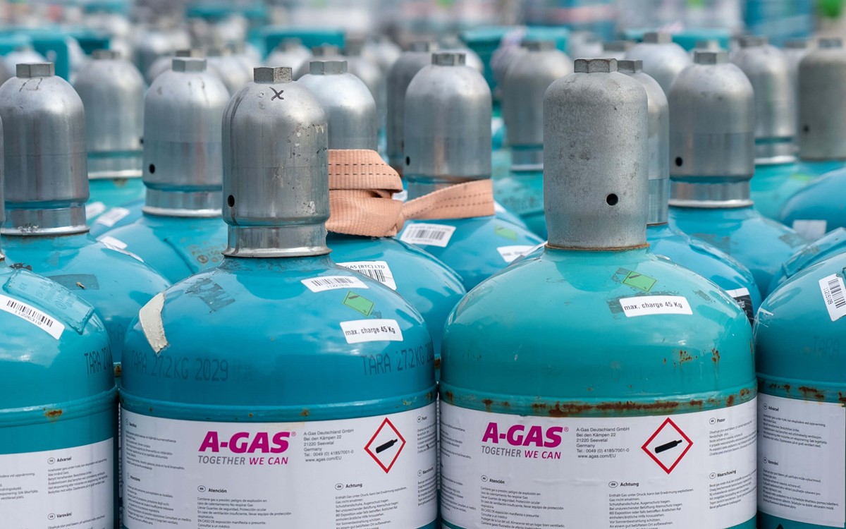 Blue cylinders with grey metal tops outside 