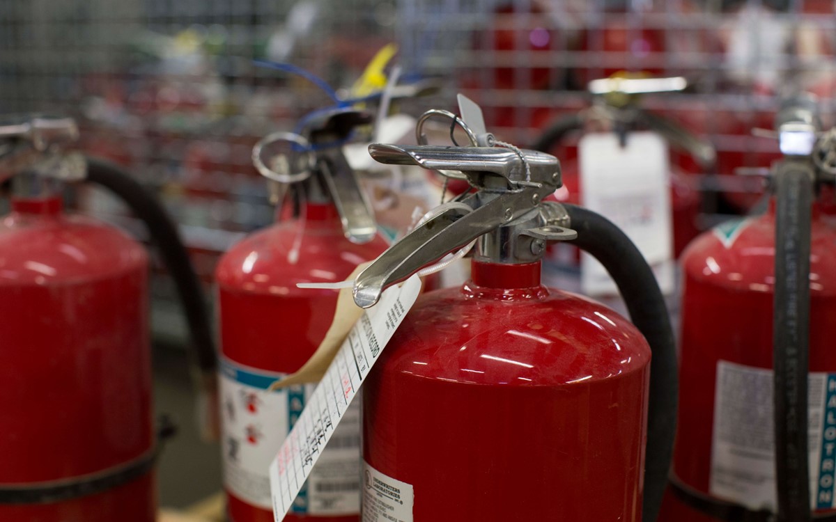 A close up of fire extinguishers grouped together
