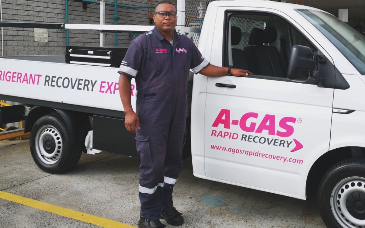 A man standing next to a white truck 