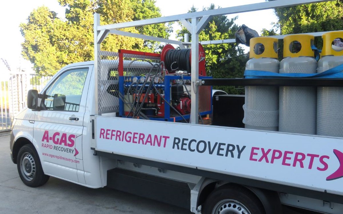 A white van with silver and yellow cylinders on the back 