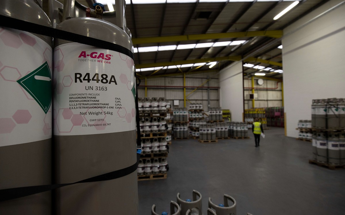 warehouse of gas cylinders with R448A cylinder up close