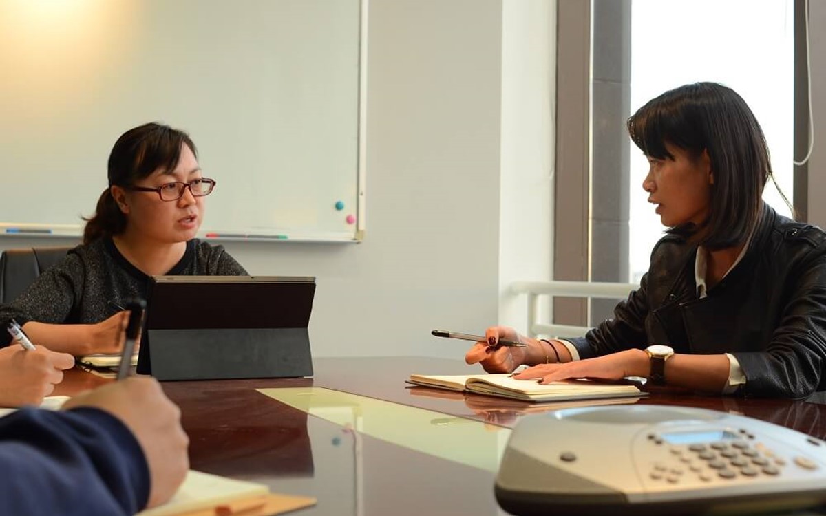 Two women in a boardroom having a meeting