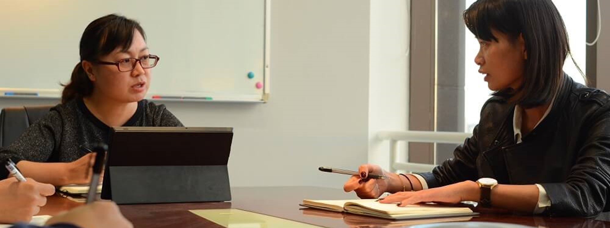 Two women in a boardroom having a meeting