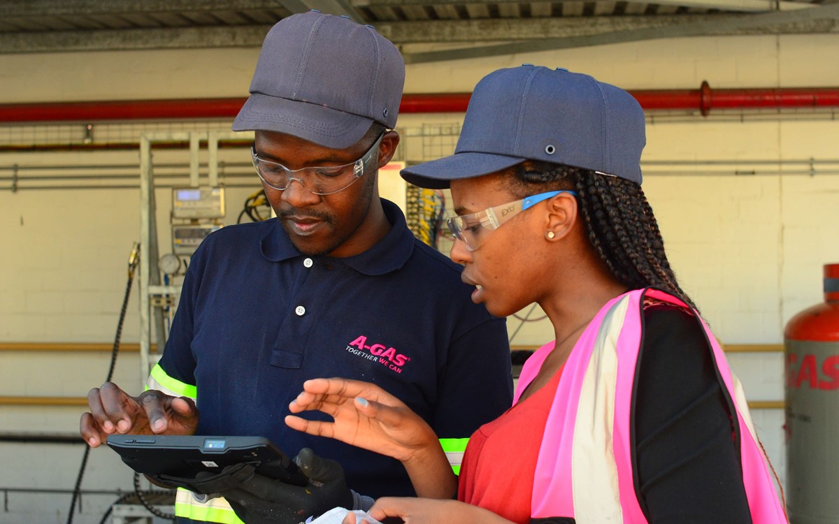 Two people working together on site, they are looking at a tablet