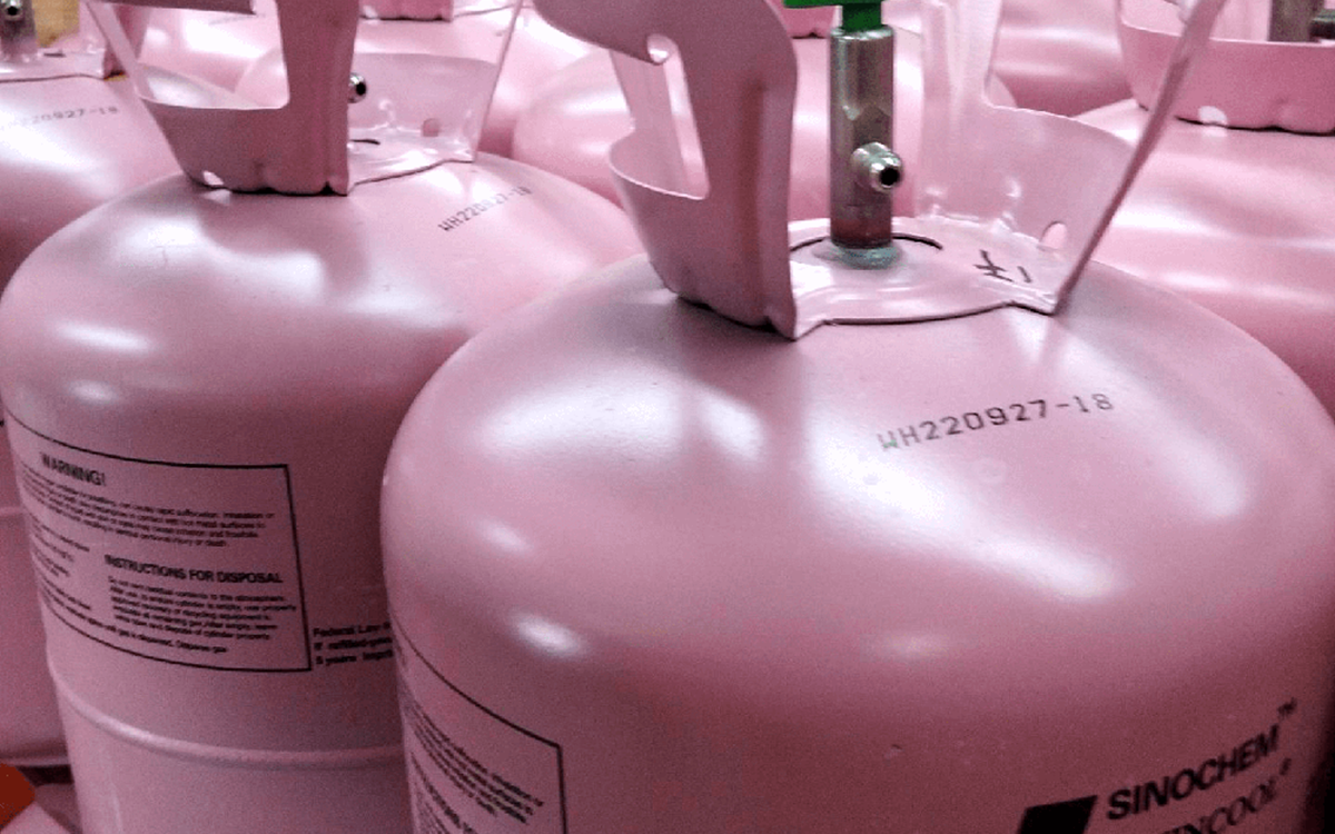 Rows of pink disposable cylinders in a warehouse 