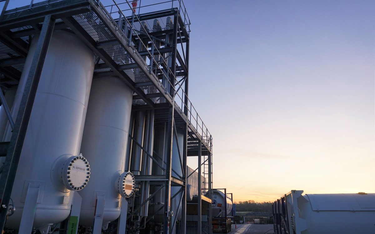 A gas separator, wide shot under a sunset